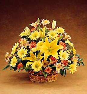 fall arrangement with autumn colored flowers such as mini 		Carnations, Daisy Pompons, Mini Lilies, Aster and Lilies.