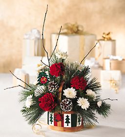 Christmas arrangement of white and red flowers and chirstmas 	greens in a country basket