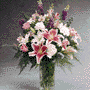 Vase arrangement Larkspur, Roses, Alstroemeria and Star Gazer 
Lilies.