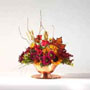 fall arrangement with autumn colored flowers such as mini Carnations, Daisy Pompons, Mini Lilies, Aster and Lilies.