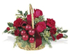 holiday basket arrangement is filled with Christmas greens, red carnations, red roses, red berries and ribbon.
